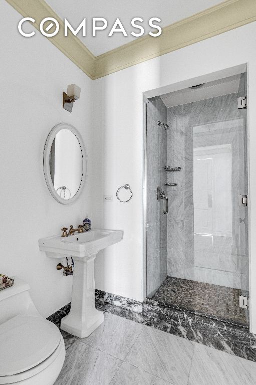 bathroom with toilet and a shower with shower door