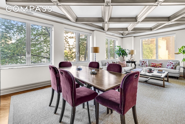 dining room with coffered ceiling, ornamental molding, baseboard heating, and beam ceiling