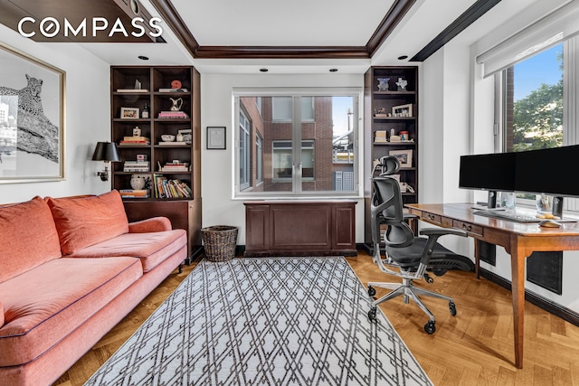 office featuring a tray ceiling, built in features, and crown molding