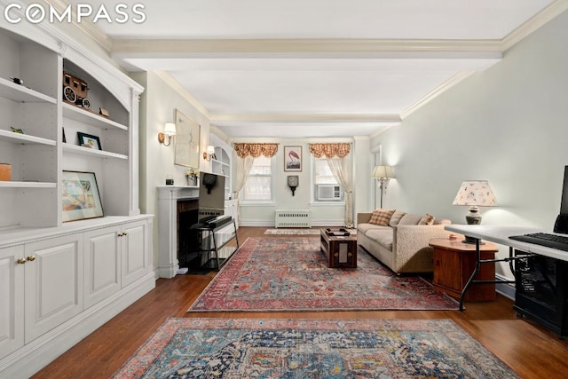 living room featuring built in shelves, dark hardwood / wood-style floors, radiator, and crown molding