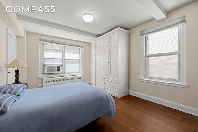 bedroom with beam ceiling, radiator heating unit, cooling unit, baseboards, and dark wood-style flooring