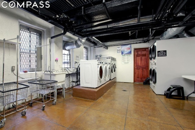 clothes washing area with sink and independent washer and dryer