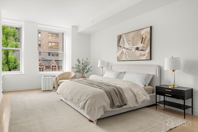 bedroom with wood finished floors and baseboards