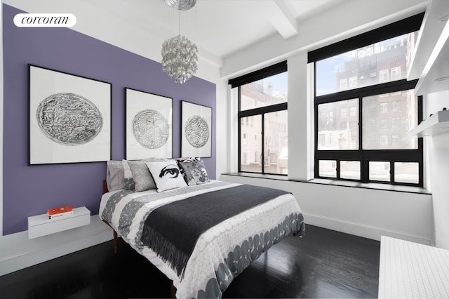 bedroom featuring wood finished floors, baseboards, visible vents, an inviting chandelier, and beam ceiling