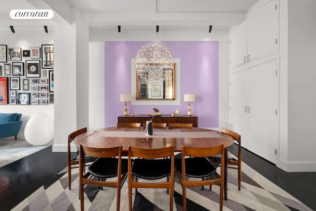 dining area with an inviting chandelier, light wood-style flooring, baseboards, and visible vents