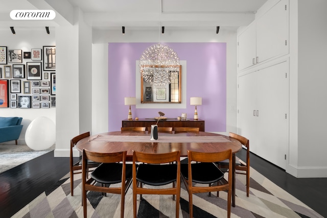 dining room featuring light wood-style floors, baseboards, and a notable chandelier