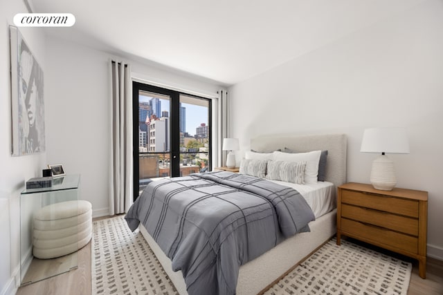 bedroom featuring french doors and light hardwood / wood-style floors