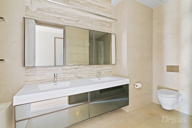 bathroom with vanity, toilet, tile patterned flooring, and tile walls