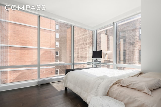 bedroom with wood-type flooring and expansive windows