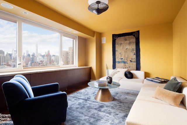60 E End Ave Unit 24/25A, New York City, NY 10028 - living area with a skyline view, healthy amount of natural light, wood finished floors, and recessed lighting