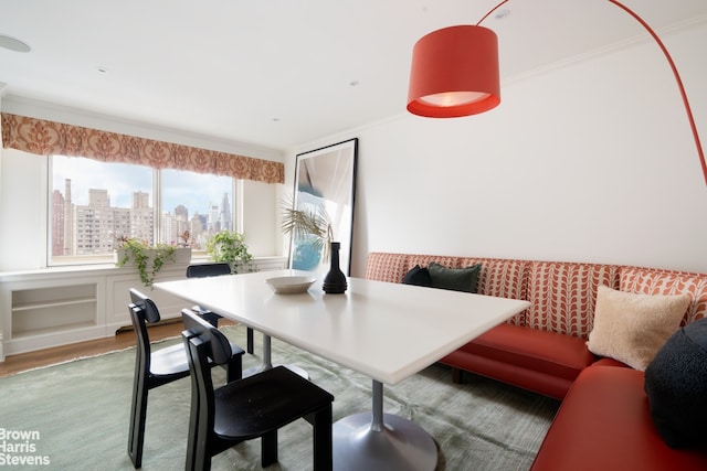 60 E End Ave Unit 24/25A, New York City, NY 10028 - dining room featuring crown molding, a city view, breakfast area, and wood finished floors