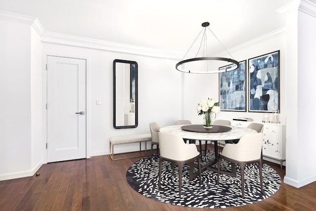 dining space with dark hardwood / wood-style floors, ornamental molding, and a notable chandelier