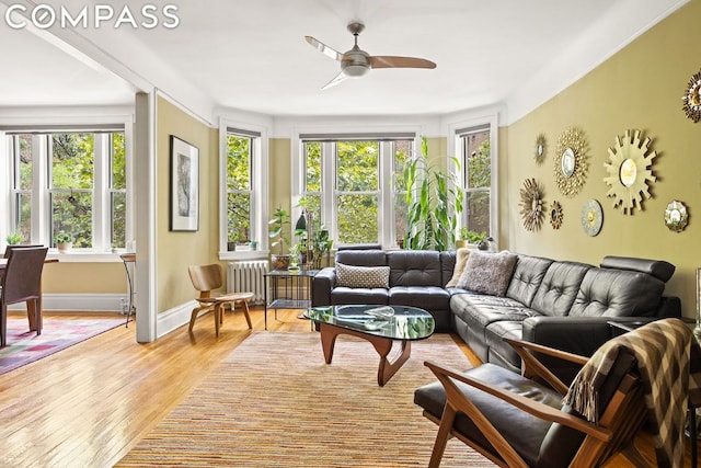 sunroom with ceiling fan, plenty of natural light, and radiator