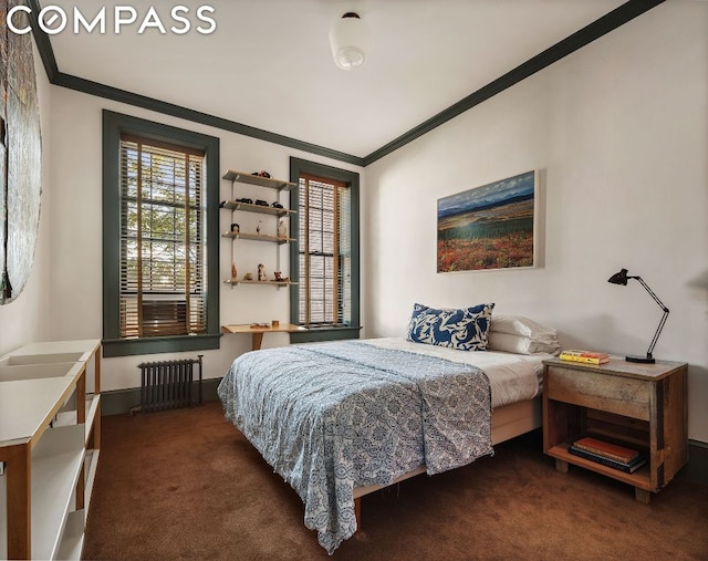 bedroom featuring dark colored carpet, crown molding, and radiator heating unit