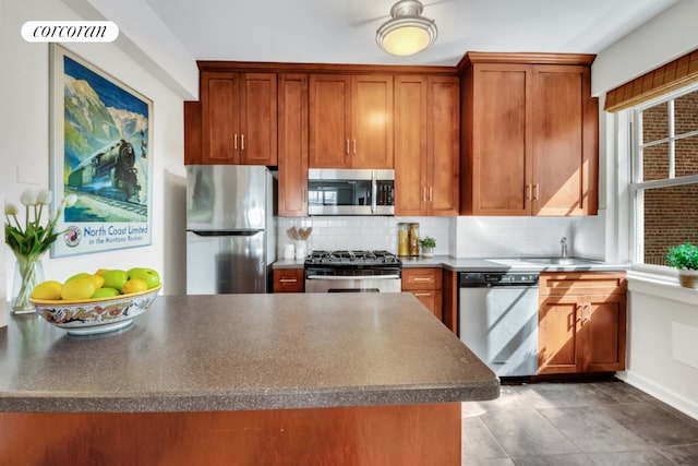 kitchen with stainless steel appliances, tasteful backsplash, and sink