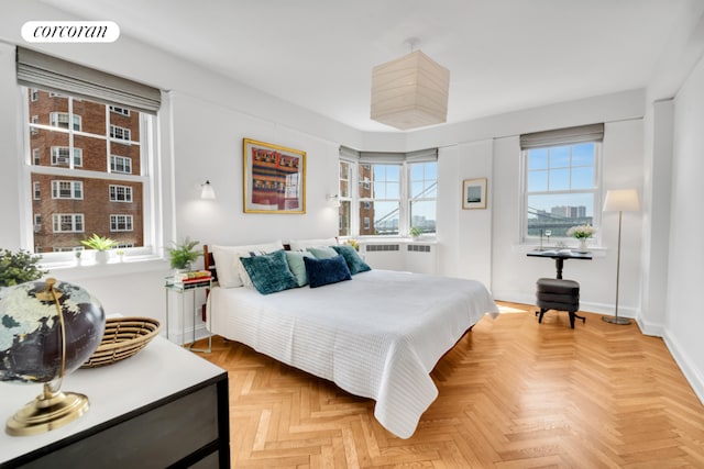 bedroom featuring radiator heating unit and parquet flooring