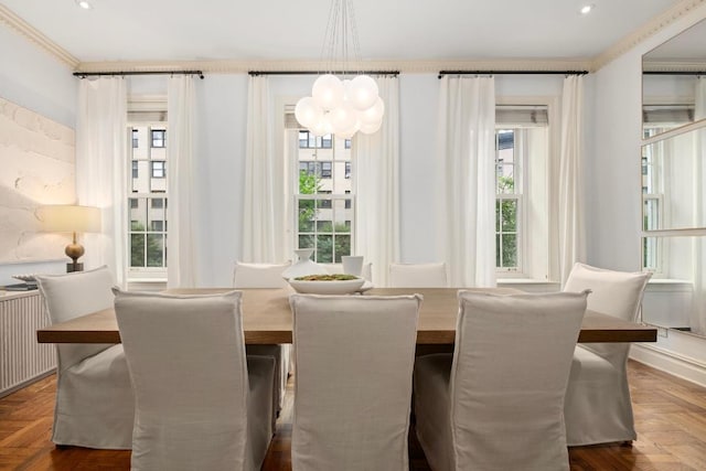 dining area featuring a chandelier, radiator heating unit, crown molding, and dark parquet floors