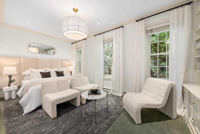 bedroom featuring crown molding and dark carpet