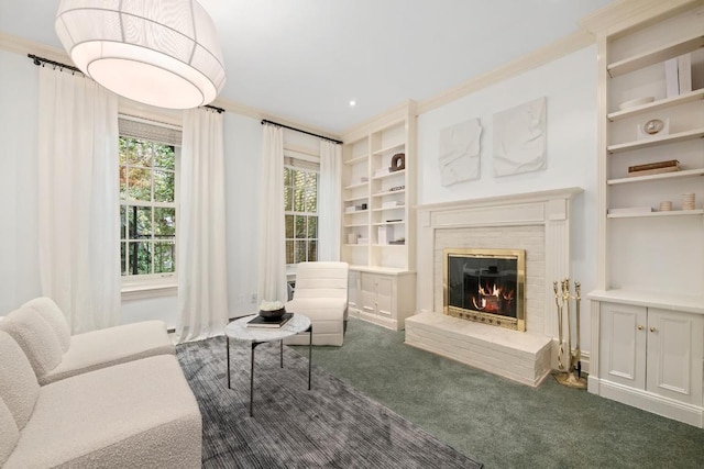 carpeted living room with built in features, a fireplace, and ornamental molding