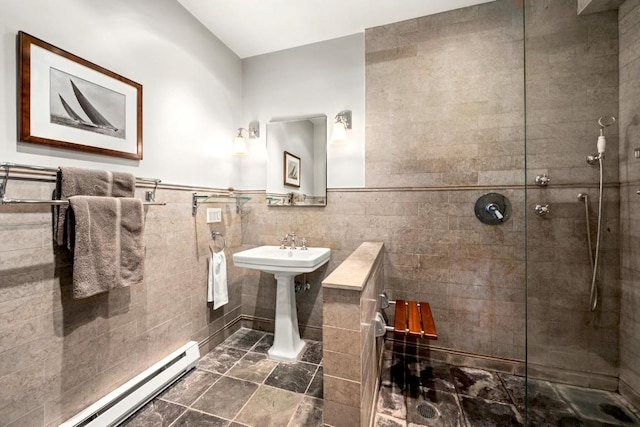 bathroom with baseboard heating, tile walls, and a tile shower