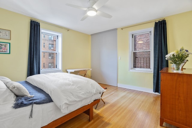 bedroom with light hardwood / wood-style floors and ceiling fan