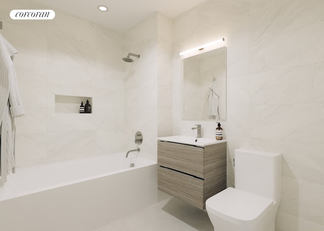 bathroom featuring toilet, recessed lighting, bathing tub / shower combination, vanity, and tile walls