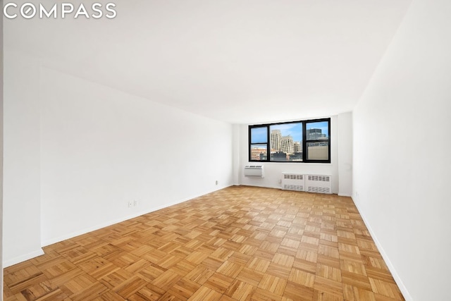 unfurnished living room with light parquet flooring and radiator