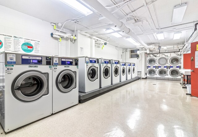 common laundry area with independent washer and dryer and stacked washer and clothes dryer