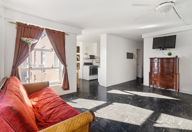 living area with ceiling fan and dark floors