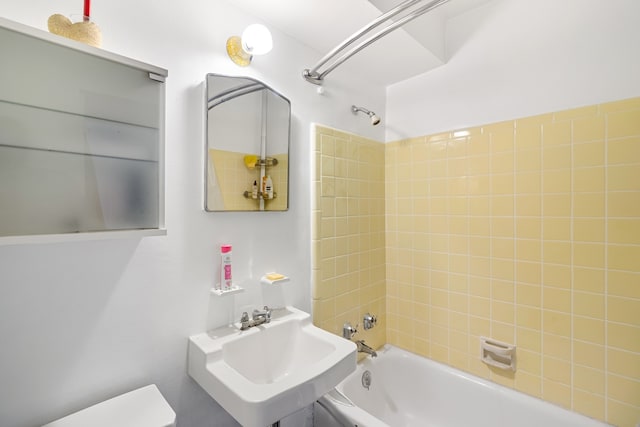 full bath featuring shower / washtub combination, toilet, and a sink