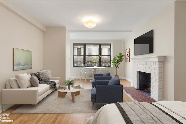 living room with hardwood / wood-style floors and a fireplace