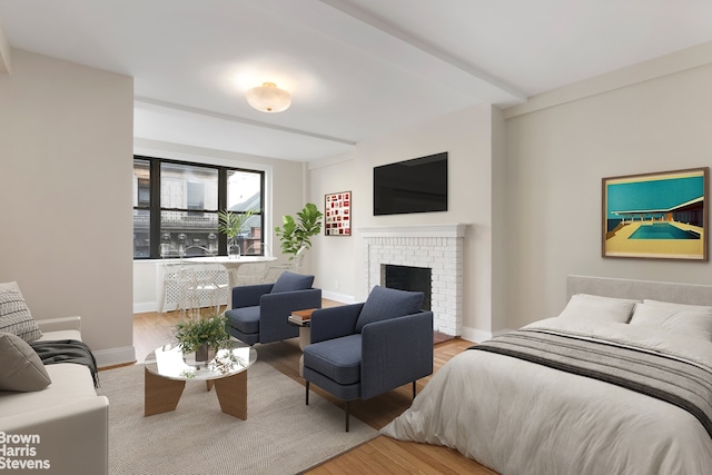 bedroom featuring a fireplace and light hardwood / wood-style flooring