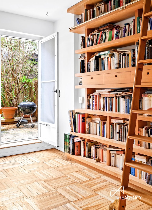 living area featuring wall of books