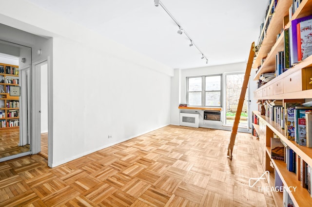 interior space with baseboards and track lighting