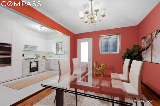 dining area featuring hardwood / wood-style flooring and a notable chandelier