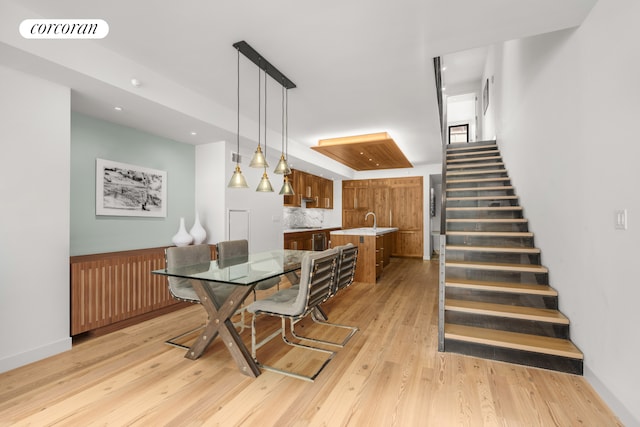 dining area with light wood finished floors, recessed lighting, visible vents, and stairway