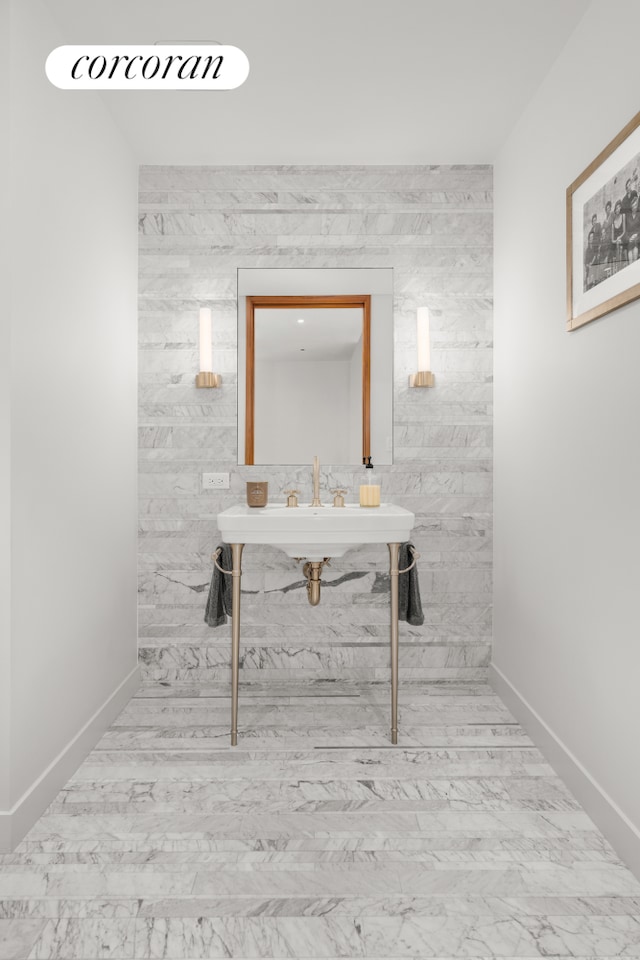 bathroom featuring baseboards and marble finish floor