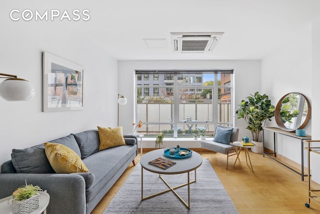 living area with light wood-style flooring and baseboards