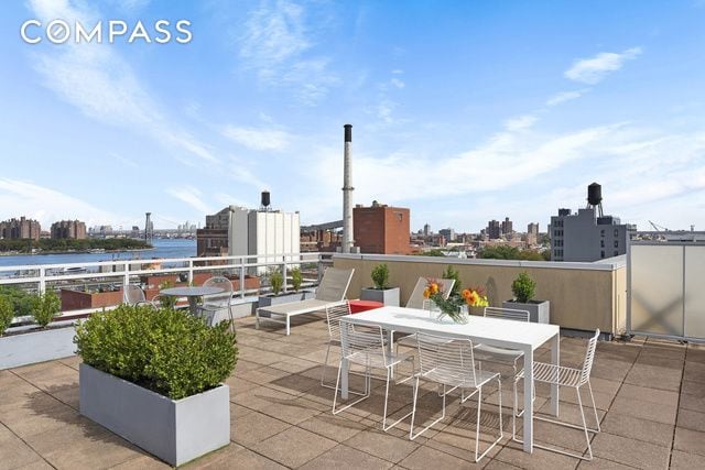 view of patio featuring outdoor dining space, a water view, and a city view