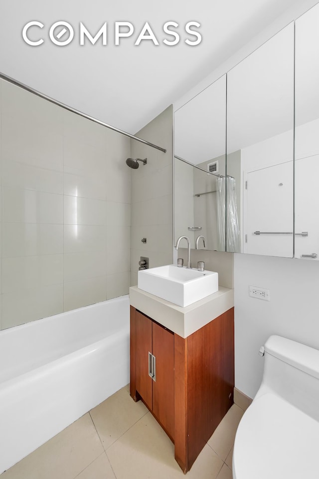 full bath featuring shower / bathtub combination with curtain, vanity, toilet, and tile patterned floors