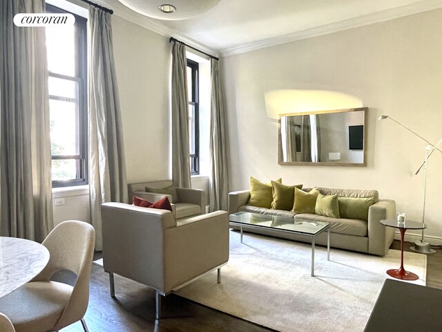 living room featuring hardwood / wood-style flooring and ornamental molding