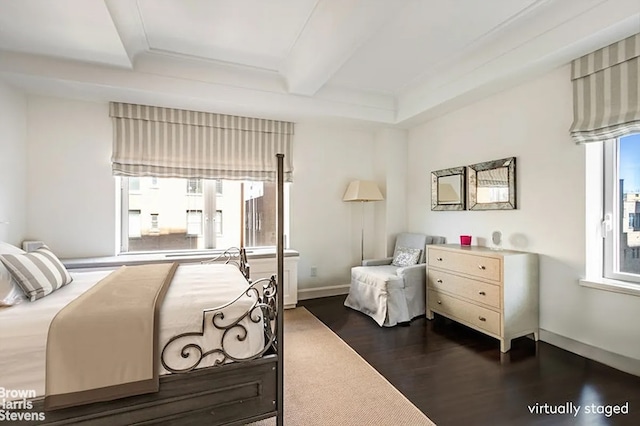 bedroom featuring baseboards, dark wood finished floors, and beamed ceiling