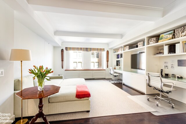 office featuring built in desk, wood finished floors, and ornamental molding