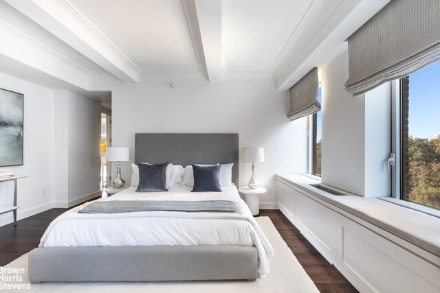bedroom with beamed ceiling, dark wood-style flooring, and multiple windows