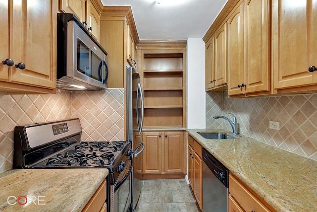 kitchen featuring sink, backsplash, light stone countertops, and appliances with stainless steel finishes