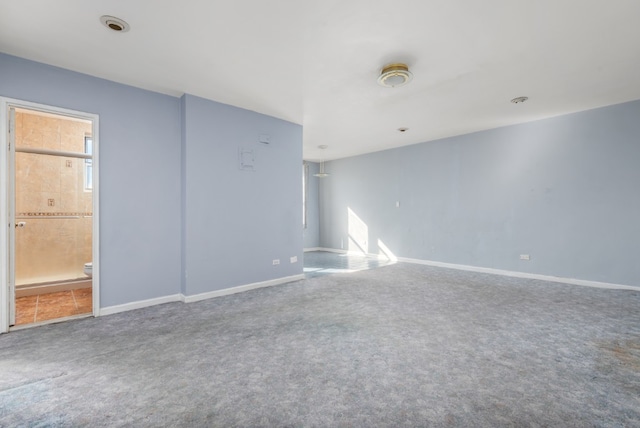 carpeted spare room with baseboards