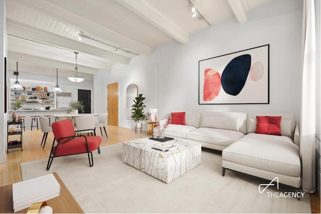 living room with rail lighting, beamed ceiling, and light wood-type flooring