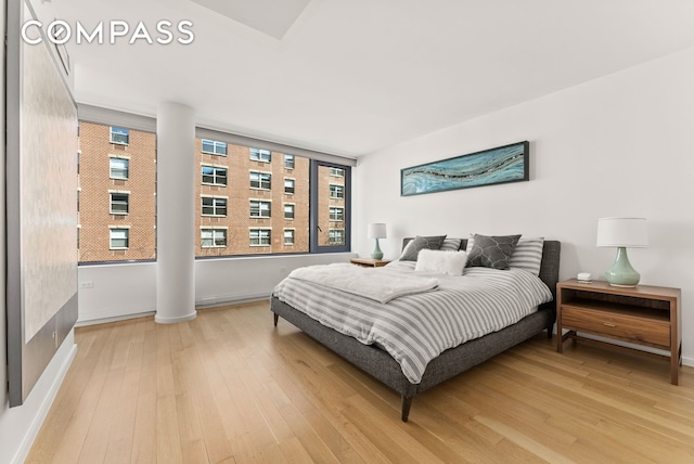 bedroom with light wood finished floors