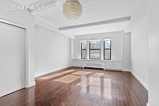 interior space featuring radiator heating unit, baseboards, beam ceiling, and wood finished floors