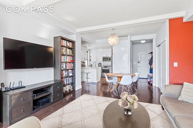 living room with beamed ceiling and dark wood-type flooring